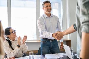 Employees shaking hands with each other in the office