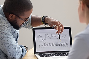 a business owner analyzing data with her new outsourced CIO